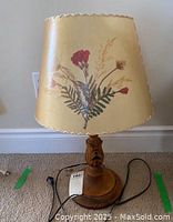 Full view of wooden lamp with pressed flower Dornbusch lampshade, showing floral design and scalloped edges.