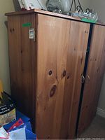 Side and top view of the pine cabinet showing wood grain and knots.