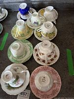 Overview of nine teacups and saucers showing various patterns and brands.