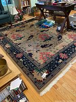 Overhead view of full 8x10 area rug showing border, field pattern and fringe on one end