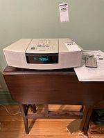 Front view of unit on table showing digital display reading time.