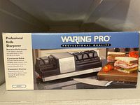 Box of Waring Pro Professional Knife Sharpener model KS80C with branding and feature list.