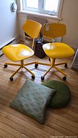Two yellow chairs side by side under window showing overall appearance