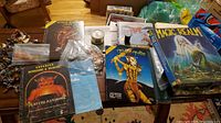 Overview of AD&D books, modules, Magic Realm box, rulebook and bag of cardboard tokens on table