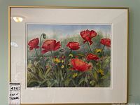 Frontal photo of the framed artwork showing vibrant red poppies and yellow flowers with a white mat and gold frame.