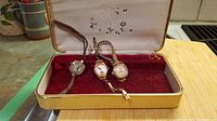 Three vintage ladies wristwatches in a velvet-lined case, showing general lot contents.