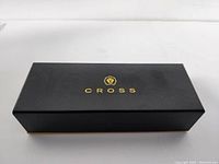 Closed black Cross branded pen box with gold logo on lid