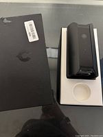 Black Canary security camera on white molded packaging tray and black box with label on top.