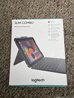 Front of box showing Logitech Slim Combo keyboard case for iPad 5th and 6th generation in black.