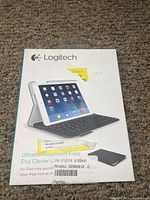 Box of Logitech Ultrathin Keyboard Folio wireless keyboard and cover case for iPad Mini shown front side with product image