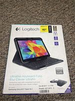 Photo of Logitech Ultrathin Keyboard Folio box for Samsung Galaxy Tab 4 10.1 showing product image and key features.