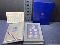Full display with coin set, suede display case, original blue Franklin Mint storage box and coin specification chart