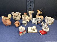 Full set of 12 Artesania Rinconada animal figurines arranged side by side showing variety and size