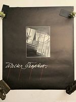 Black poster with white photo of architectural interior and Walter Gropius signature