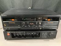 Sony dual cassette deck positioned above Yamaha C-50 amplifier, showing front panels and controls