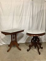 Both marble-top side tables on display