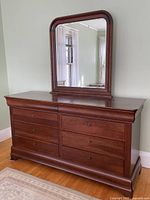 Frontal view of dresser with attached mirror