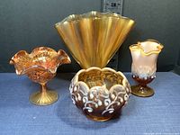 Four vintage glass pieces including Fenton cameo opalescent potpourri bowl, unmarked flute edge vase, marigold carnival glass candy dish, and fan vase.