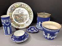 Full lot including cobalt blue jasperware pieces and Wedgewood commemorative plate shown on black background