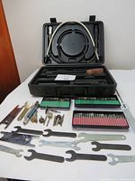 Full view of mini grinder set showing case, three boxes of grinding bits, wrenches, and shaft attachments.