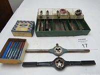 Full lot image showing the green organizer tray with multiple taps and dies, a blue box with taps, and two die handles laid out in front.