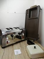 Photo showing Mickey Mouse four-slot toaster and brown Jubilee griddle with lid