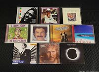 Top view of the 10 CD jewel cases showing cover art and artists