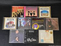Top view of 10 assorted CDs showing front cover artwork including Reservoir Dogs, Beatles Greatest Hits, Van Morrison, and others.