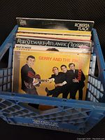 Photo showing vinyl records in blue crate with visible album covers of Gerry and the Pacemakers, Rod Stewart, Boz Scaggs, Roberta Flack.