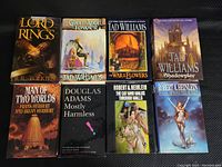 Top covers of 8 hardcover fantasy and sci-fi books showing titles and authors