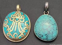 Front view of both pendants showing turquoise stones and silver details