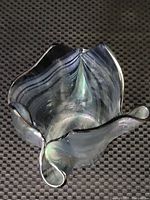 Top view showing the irregular, flowing edges and iridescent colors of the glass.