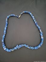 Full view of the necklace laid flat showing the length and bead distribution.