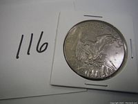 Reverse side of 1974 U.S. silver dollar coin showing eagle design with inscriptions.