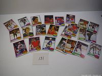 All 24 hockey cards laid out on a white surface, showing front side of each card with player image and team information.