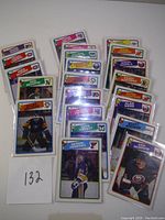 Photo showing all 22 hockey cards laid out together with a paper marked '132'.