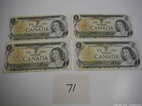 Four Canadian one dollar bills displayed with a paper marked '71' for lot identification.