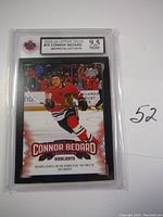 Front of the Connor Bedard rookie card showing the player on ice celebrating, graded 9.5 by NGM.