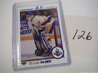Front image of Curtis Joseph rookie card from 1990-91 Upper Deck showing him as St. Louis Blues goaltender with rookie card notation.
