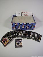 Extra large box of 1992 Pinnacle hockey cards with holiday-themed box and a spread of cards in front.