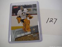 Front view of Marc Andre Fleury rookie hockey card in protective case showing player in goalie gear and rookie designation.
