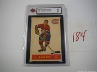 Front view of 1957-58 Parkhurst #18 Marcel Bonin hockey card graded 5 EX by KSA in protective case.