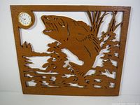 Front view of the solid oak largemouth bass clock showing full wood cutout design and small round clock in the top left corner.