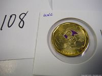 Reverse side of the 2022 Canadian loonie with Oscar Peterson design and purple colored accent, uncirculated.