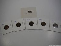 Five vintage pennies from 1940 to 1944 in protective holders, labeled with year and quantity '100' noted.