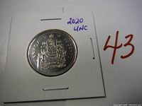 Obverse side of the 2020 Canadian 50 cent coin showing the Canadian coat of arms, preserved in a cardboard flip.