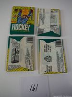 Four 1990-91 hockey wax card packs shown flat with wrappers partially open but no cards removed.