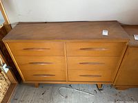 Front view of six drawer dresser showing veneer finish and drawer handle design.