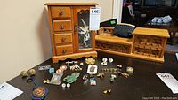 Overall view showing two wooden jewelry boxes and an assortment of jewelry items laid out on a black surface