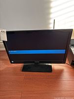 Front view of the 24-inch Toshiba TV powered on showing 'no video signal' message.